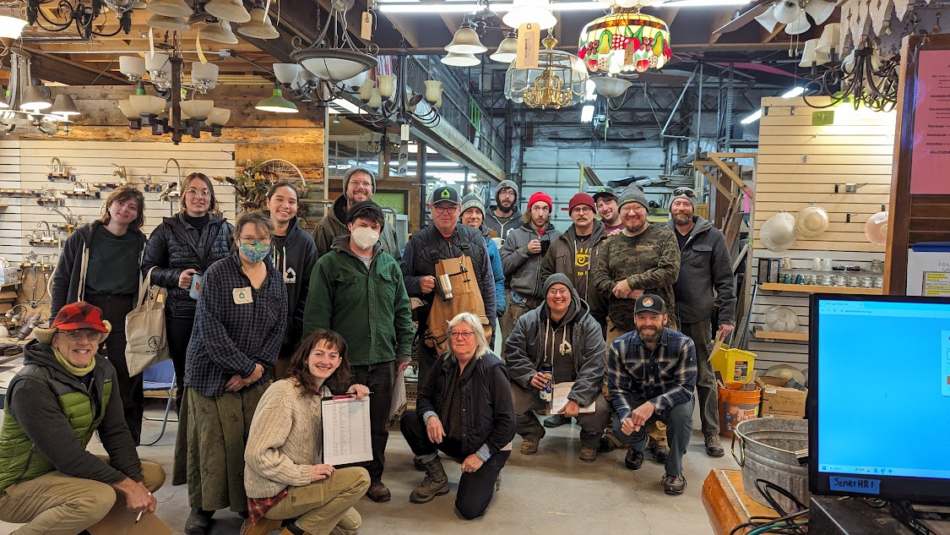 Group of Home ReSource staff standing a in the ReUse Store, staff picture.