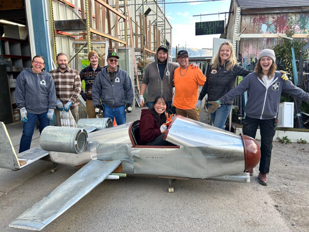 Home ReSource Team sits in a SponCon creation created by the team The Bomber Boys